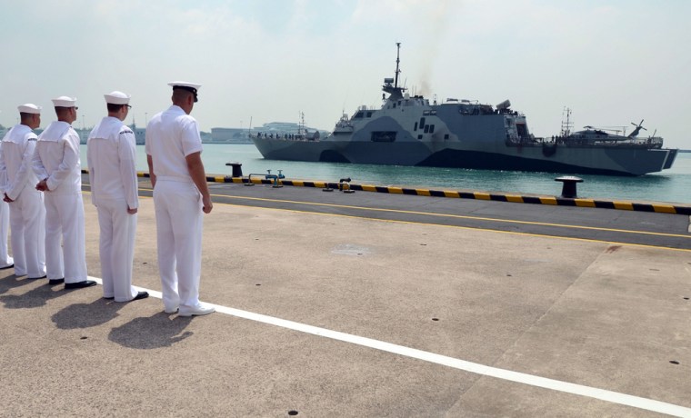 U.S. Navy sailors look at the USS Freedom as it arrives at Singapore's Changi Naval Base on April 18.