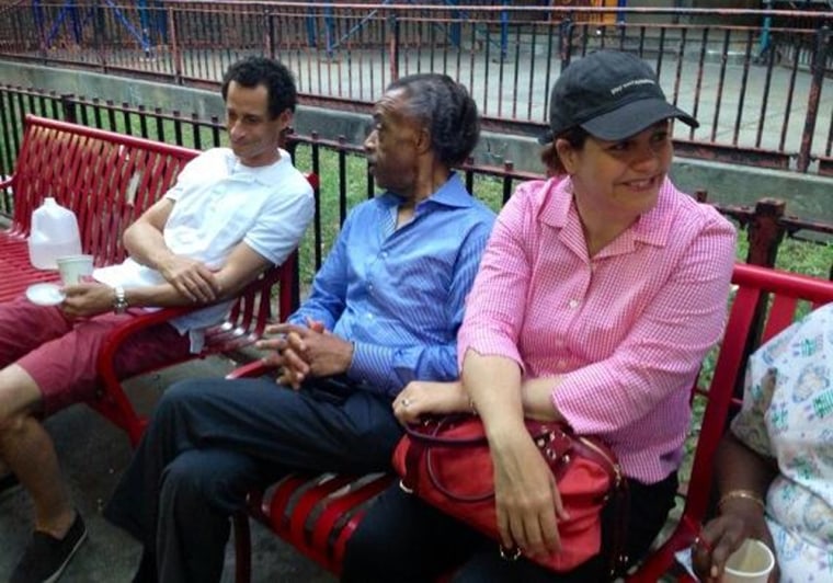 New York City mayoral candidates Anthony Weiner, left, and Christine Quinn, right, with the Rev. Al Sharpton outside the public housing where they spent the night.