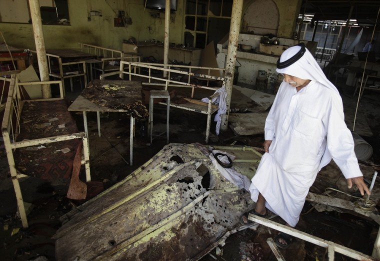 A man inspects the damage at a cafe in Balad on Tuesday, following a suicide bombing on Monday evening.