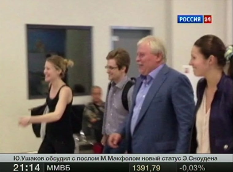 Fugitive former U.S. spy agency contractor Edward Snowden, Sarah Harrison, a legal researcher for WikiLeaks, Russian lawyer Anatoly Kucherena, and his assistant Valentina walk at Moscow's Sheremetyevo airport on Aug. 1, in this still handout image broadcasted by Rossiya 24 TV Channel.
