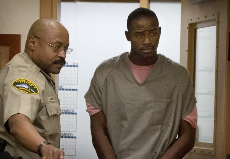 Pvt. Jeremiah DeShaun Hill, right, during his arraignment Thursday in Tacoma, Wash. Hill was held on $2 million bond on a murder charge in the stabbing death of Spc. Tevin A. Geike.