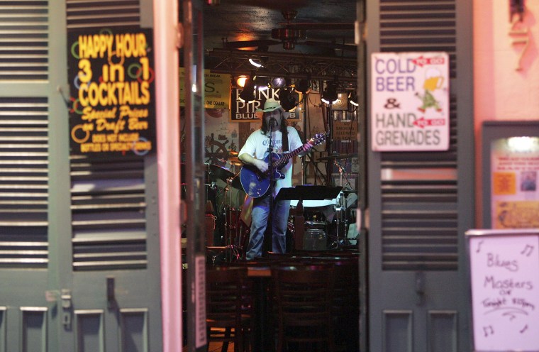 A Musician plays at an empty bar on Bourbon Street on Aug. 24, 2006, as the popular tourist destination struggled in the wake of Hurricane Katrina.