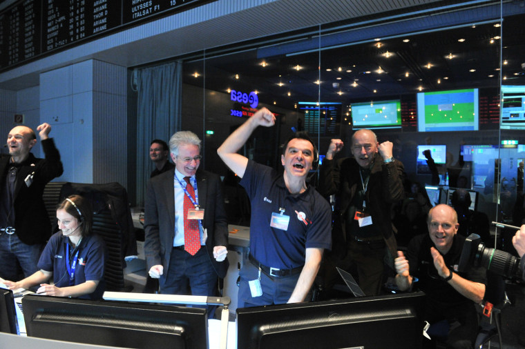 Rosetta mission scientists cheer as the comet-chasing probe's first signal after awaking from a 2.5-year sleep is received at the European Space Agency's Space Operations Center in Darmstadt, Germany on Jan. 20, 2014.