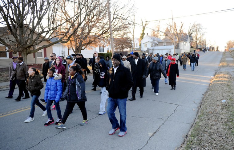 People march down Washington Street toward the Greater Norris Chapel Baptist Church during the Henderson County Black History Committee's Celebration of Martin Luther King Jr's birthday in Henderson, Ky., on Jan. 19, 2014.
