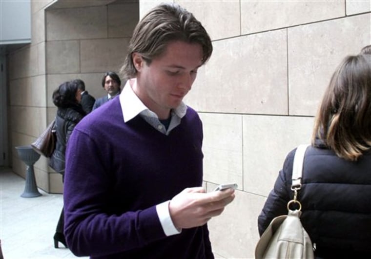 Raffaele Sollecito checks his smart phone as he enters the Florence, Italy, court on Jan. 9, 2014.