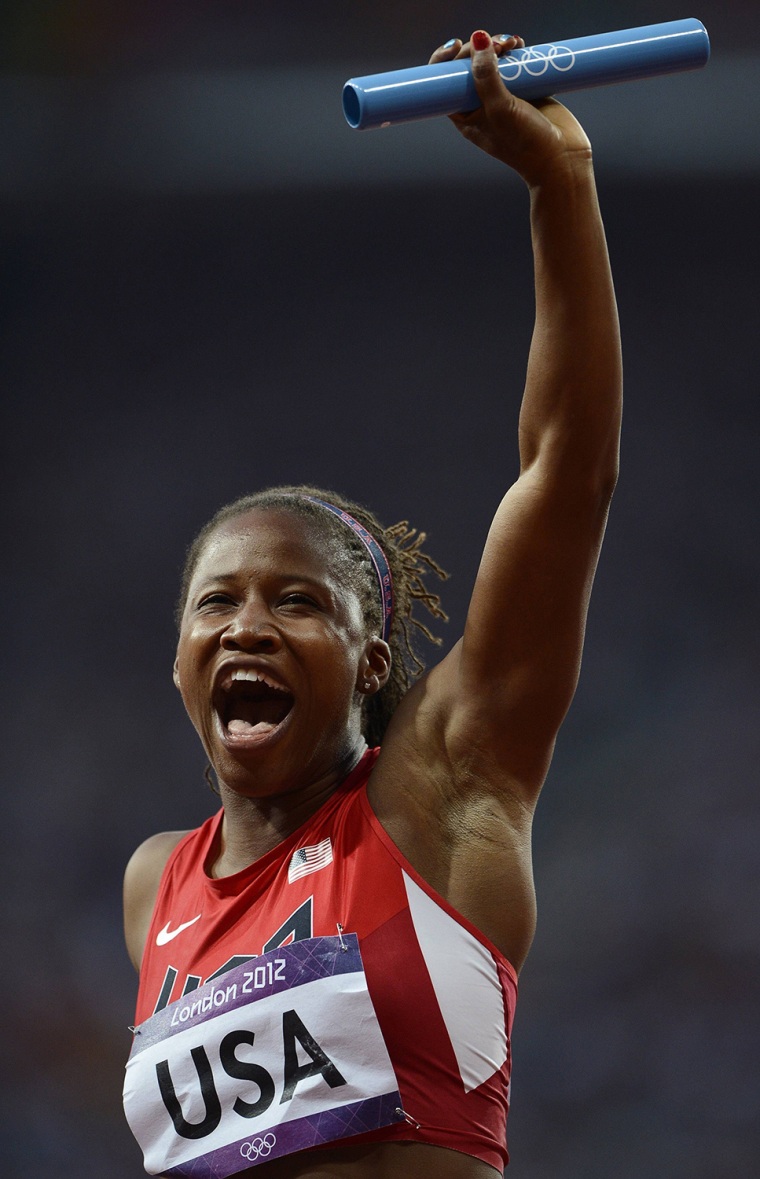 Lauryn Williams of the U.S. celebrates after her team won their women's 4x100m relay heat during the London 2012 Olympic Games at the Olympic Stadium ...