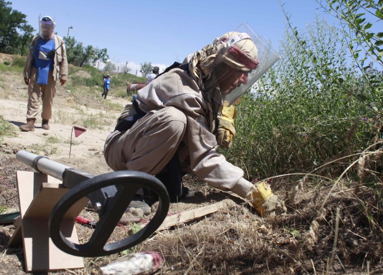 A HALO Trust worker searches for land mines in Bagram, Afghanistan, in 2009.