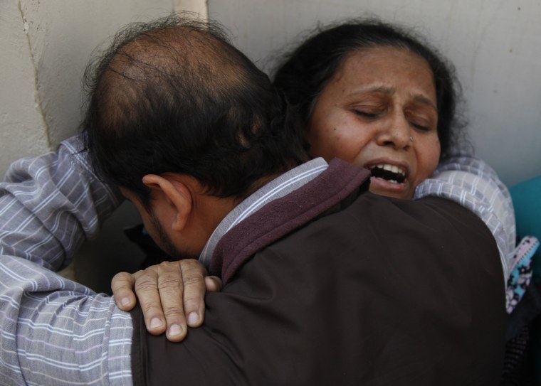 A woman mourns the death of her son who was killed by unknown gunmen in Karachi, Pakistan, on Tuesday.