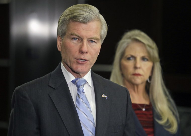 Bob McDonnell makes a statement as his wife, Maureen, listens during a news conference in Richmond on Tuesday.