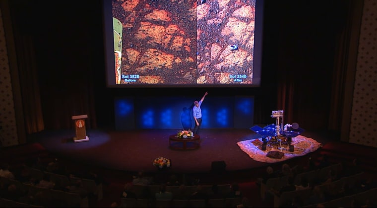 Steve Squyres, lead scientist for NASA's Mars rover Opportunity, points at a strange rock found by the rover on Jan. 8, 2014, where earlier there had been nothing, during a Jan. 16 presentation. The rock has been named