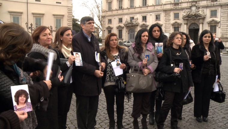 A group of Italian mothers who claim their children died of cancer after being poisoned by tons of toxic waste dumped by the local mafia gather outside Italy's presidential palace in Rome Wednesday.