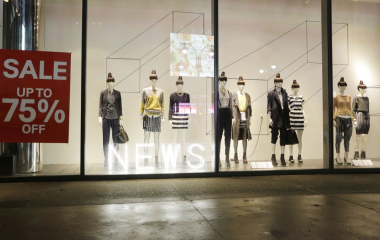 Mannequins display fashions in an H&M storefront window advertising discounts up to 75 percent on Jan. 14 in New York. Retailers are continuing their deep discounts after a disappointing holiday season.