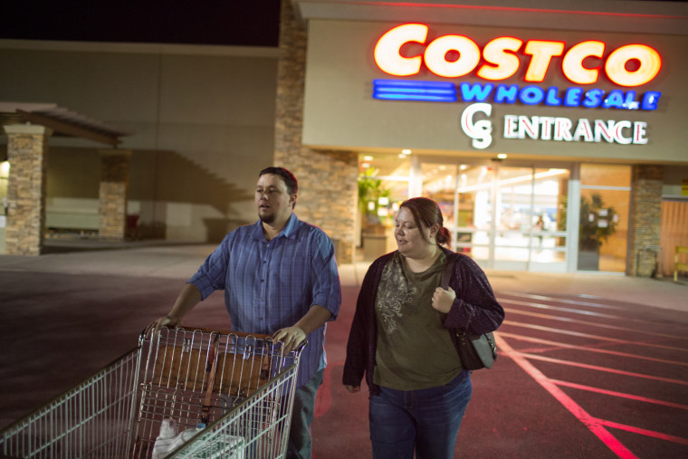 Ben and Erika Trowell exit a Costco in Phoenix, Ariz.