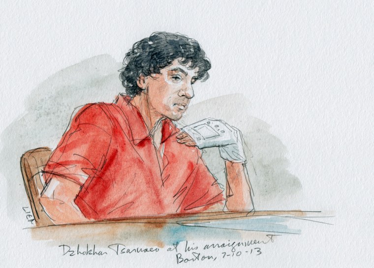 Dzhokhar Tsarnaev holds up a bandaged at his arraignment on July 10, 2013, in a courtroom sketch. The Boston Marathon bombing suspect plead not guilty to all charges on Wednesday.
