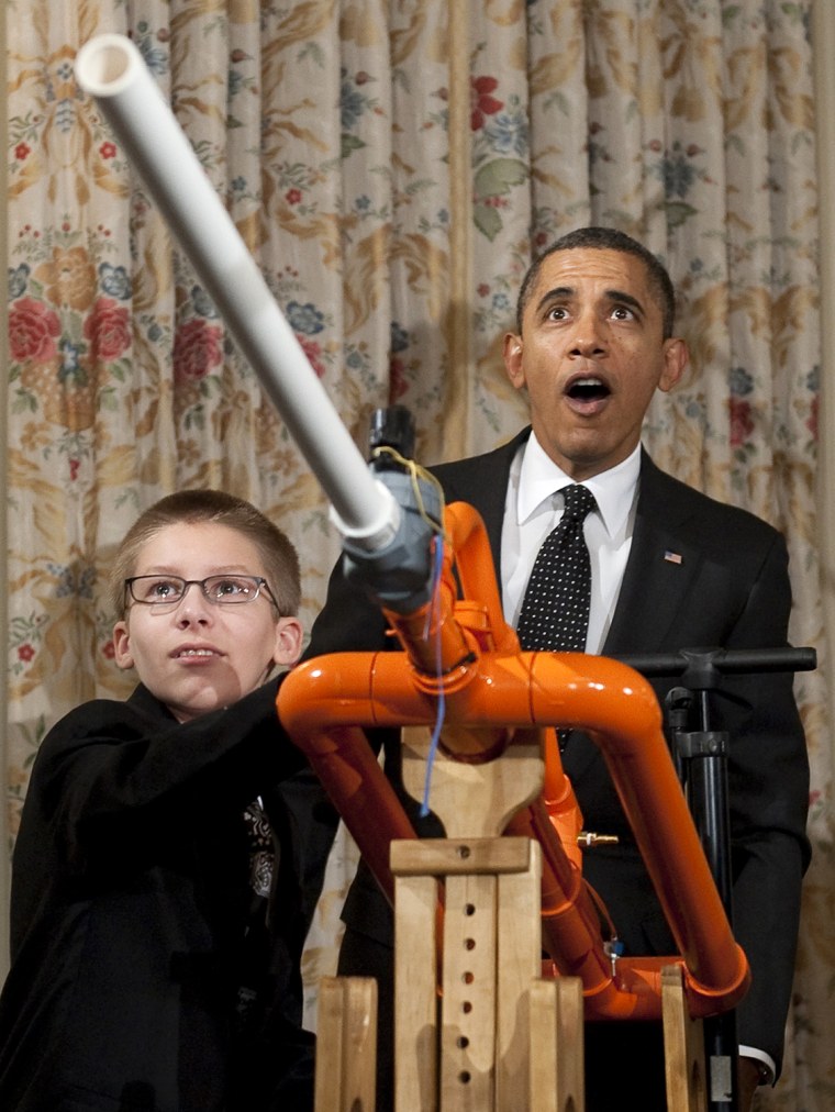 US President Barack Obama reacts as 14-year-old Joey Hudy of Phoenix, Arizona, launches a marshmallow from Hudy's \"Extreme Marshmallow Cannon\" during ...