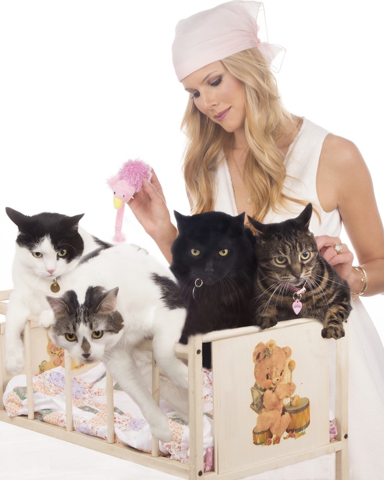 Beth Stern poses with four of her adopted cats.