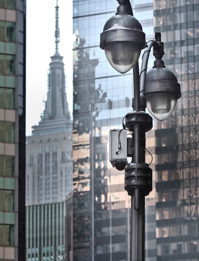 A temporary surveillance camera hangs on a Times Square light post on Thursday.
