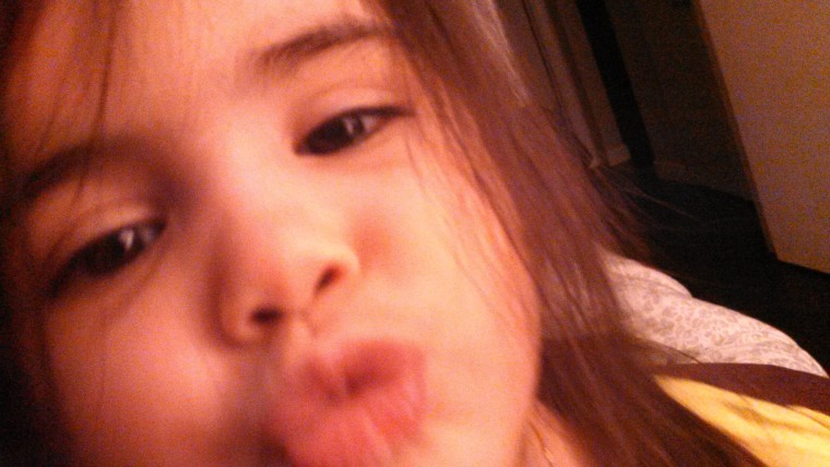 My daughter loves to give herself kisses!