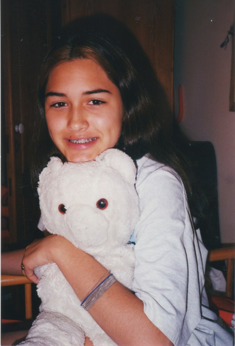 A childhood photo of Jessica Crawford with her beloved teddy bear \"Whitey.\"