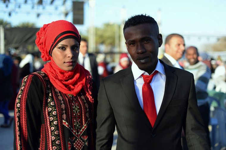Amina Mohammed Saed, 24, with her new husband Ala'a Obeid, also 24.