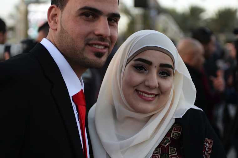 Izzat abu Hilu, 26, and his bride Rajaa' Hilu, 21.