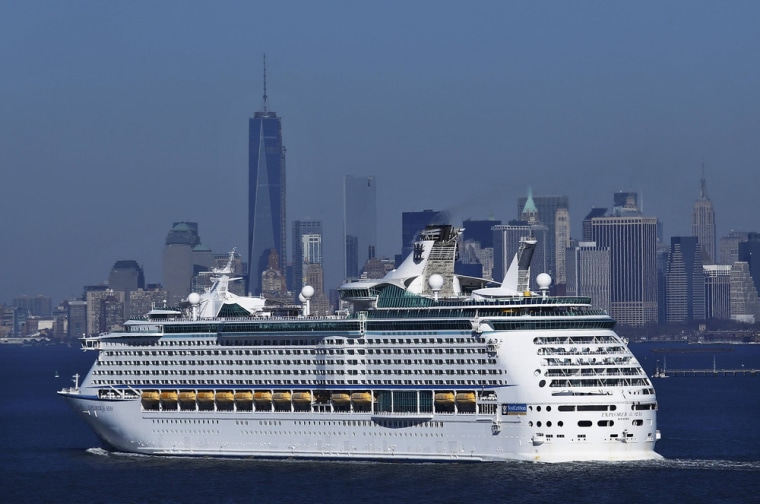 The New York skyline is seen in a distance as Royal Caribbean's Explorer of the Seas enters New York harbor on Wednesday following an outbreak of gastrointestinal illness.