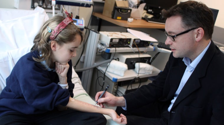 Image; Dr. Andrew Clark of Cambridge University, right, performs a skin prick test, which is used to diagnose food allergies, on Lena Barden, 12, during clinical trials at Addenbrooke's Hospital Clinical Research Facility in Cambridge, England.