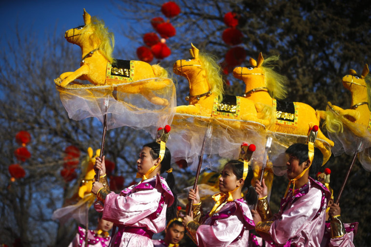 Performers do the horse dance on the eve of the Chinese New Year at a park fair in Beijing, China, on Jan. 30. The Year of the Horse, according to the symbol of the 12 year cycle of animals, will begin on 31 January.