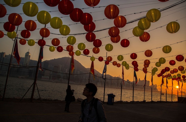 A man takes a photograph under the lanterns displayed for the Lunar New Year as China prepares for the Year of the Horse at Wet Kowloon waterfront promenade on Thursday in Hong Kong.