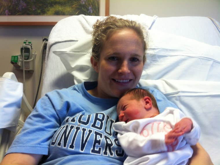 Amy Anderson and Grace Elizabeth, safe and warm after a surprise roadside birth. \"It happened so fast, I didn't even have time to panic,\" dad says.