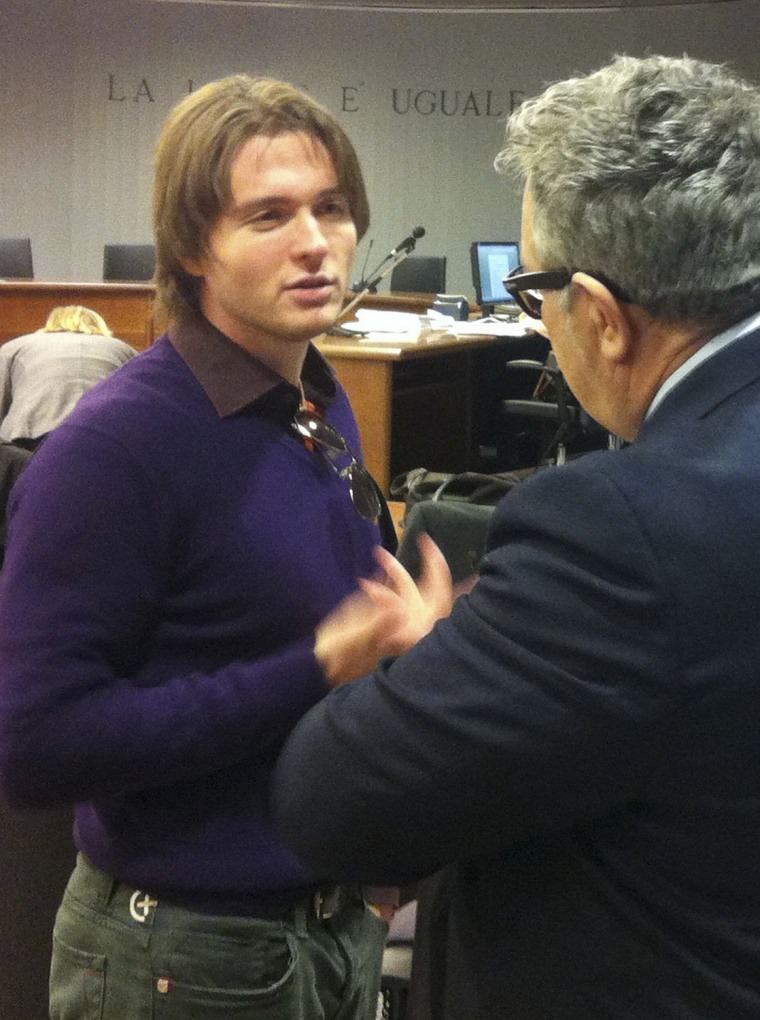 Raffaele Sollecito talks with an unidentified man prior to the start of the final hearing before the third court verdict for the murder of British stu...
