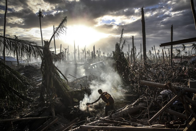 LEYTE, PHILIPPINES - NOVEMBER 19:(BEST OF 2013 PACKAGE) A man fans flames on a fire Tanauan on November 19, 2013 in Leyte, Philippines. Typhoon Haiy...