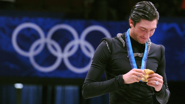Gold medallist, US Evan Lysacek, looks at his medal during the medal ceremony after performing in the Men's Figure skating free program at the Pacific...