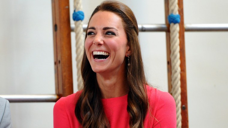 Britain's Catherine, Duchess of Cambridge laughs during a visit to an M-PACT Plus Counselling programme at Blessed Sacrament School on July 1, 2014 in...