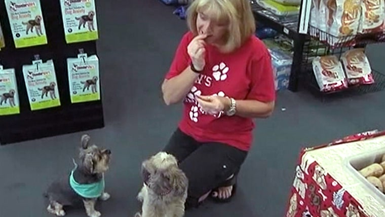 The pet food store owner is trying to demonstrate how healthy her products are.