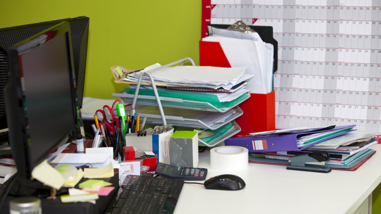 real life messy desk in office;