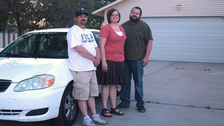 Left to right, Randy Misner, Leslie and Rob Holmes stand beside Rowan Coash's broken-down car. (Photo courtesy of the Sun Advocate)