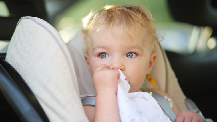 Lovely little baby girl sitting in the car in a child seat locked with safety belt; Shutterstock ID 156207527; PO: TODAY.com