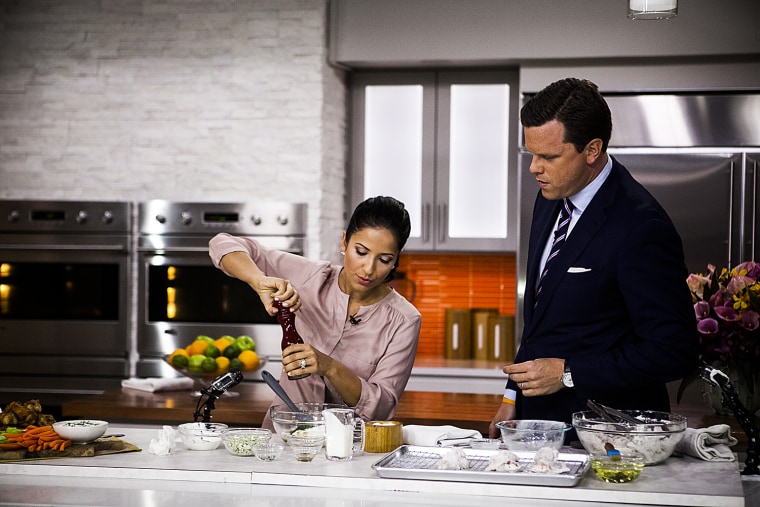 Laura Vitale and Willie Geist cook chicken wings on the TODAY show in New York, on July 7, 2014.