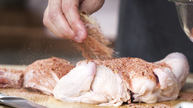 Tim Love and Willie Geist make chicken under-a-brick on the TODAY show in New York, on July 8, 2014.