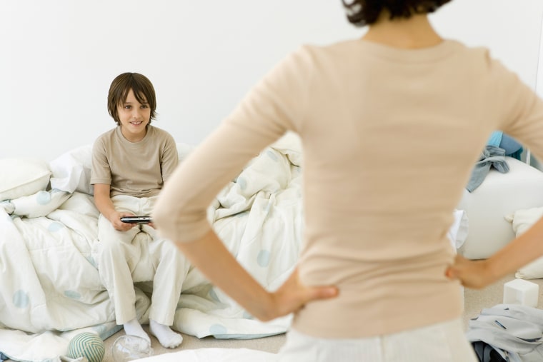 Image: A boy looks up from playing a videogame.