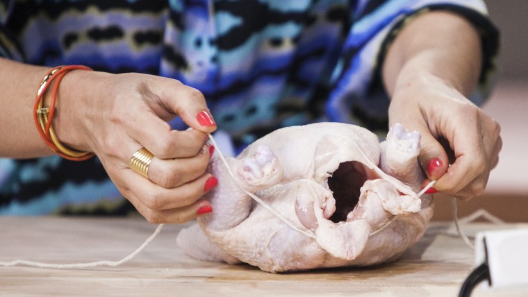 Nilou Motamed and Willie Geist cook  Thomas Keller's roasted chicken on the TODAY show in New York, on July 10.