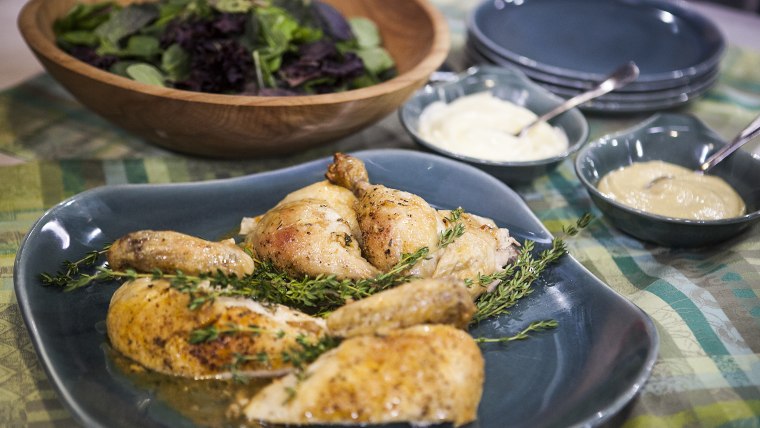 Nilou Motamed and Willie Geist cook  Thomas Keller's roasted chicken on the TODAY show in New York, on July 10.