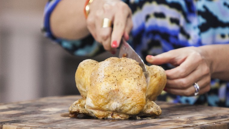 Nilou Motamed and Willie Geist cook  Thomas Keller's roasted chicken on the TODAY show in New York, on July 10.