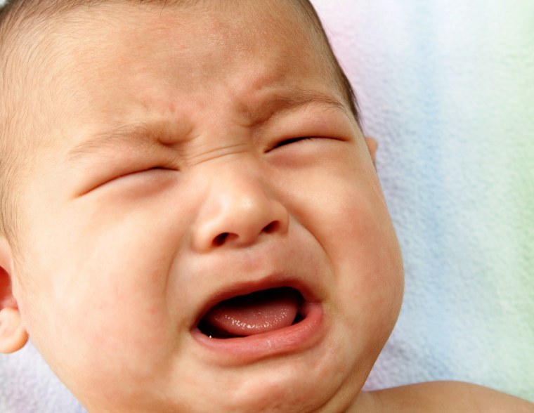 A closeup portrait of a crying baby stock 