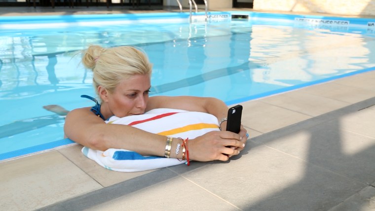 Checking the phone -- even in the pool.