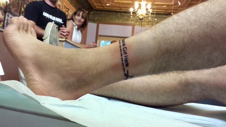 Joe Pleban's \"Please Cut Here\" tattoo near his ankle.