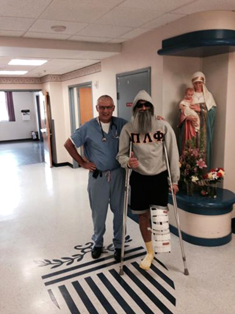 Dr. Christopher Attinger, the surgeon who amputated Joe's leg, poses for a photo as Joe wears a fake beard that he'd goof off with at the hospital.