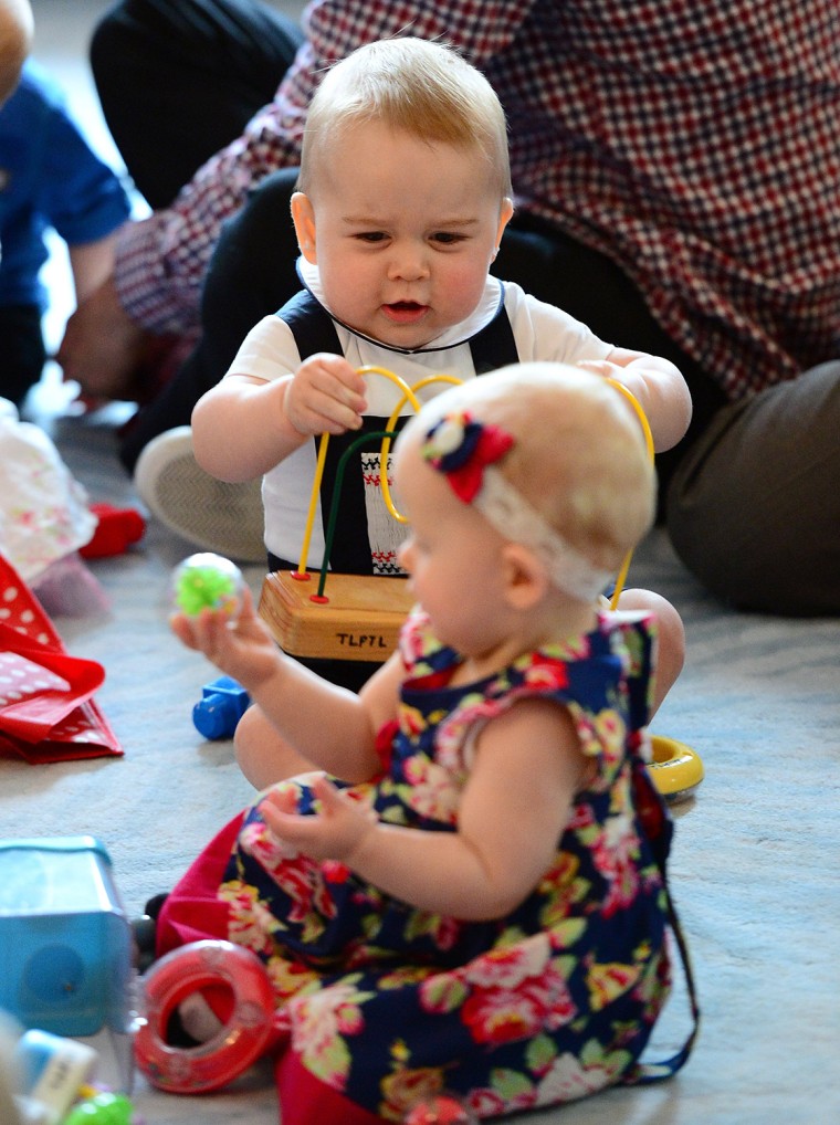 Prince George plays with toys alongside other babies while attending a parenting group at the Government House on April 9, 2014 in Wellington, New Zealand.