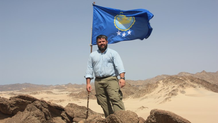 Jeremiah Heaton with the flag he designed for Egyptian land he claimed so that his daughter could be a princess.